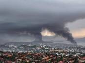 An Australian woman stranded in New Caledonia says the capital Noumea resembles a war zone. (AP PHOTO)